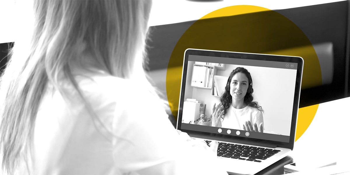 A marketing rep having a video chat with a client on her laptop