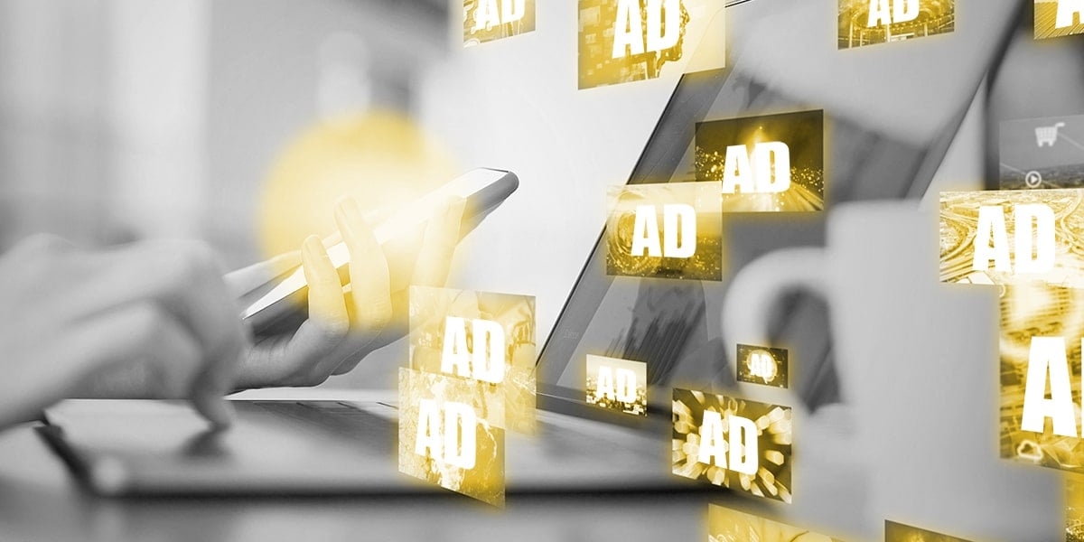 Digital display ads float out of a laptop screen and mobile phone