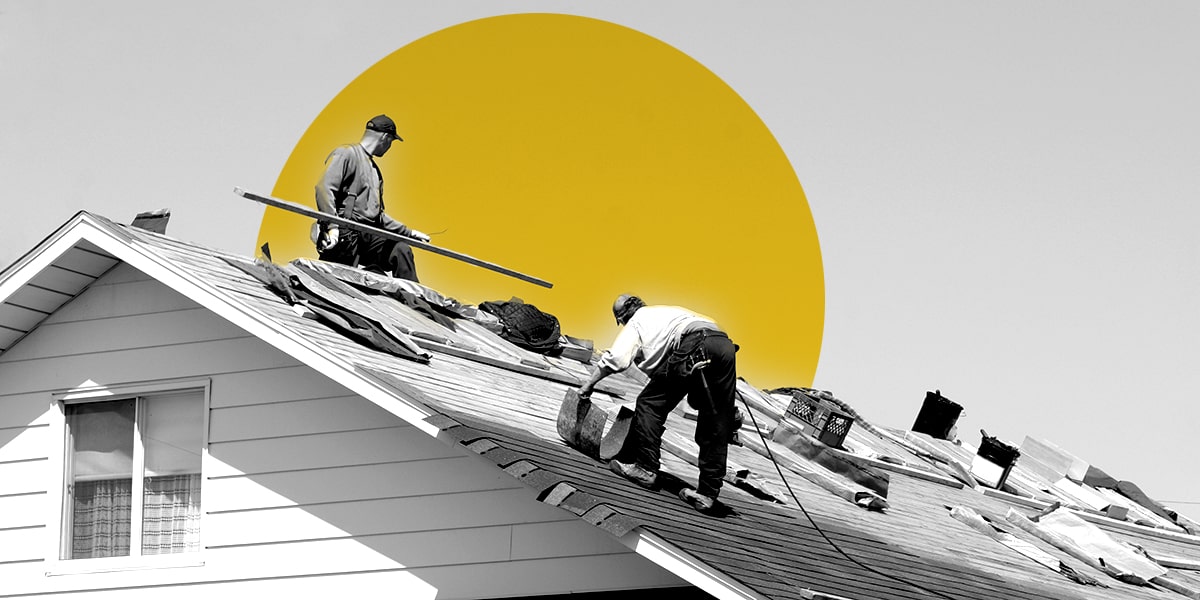 Construction workers replacing a roof on a house