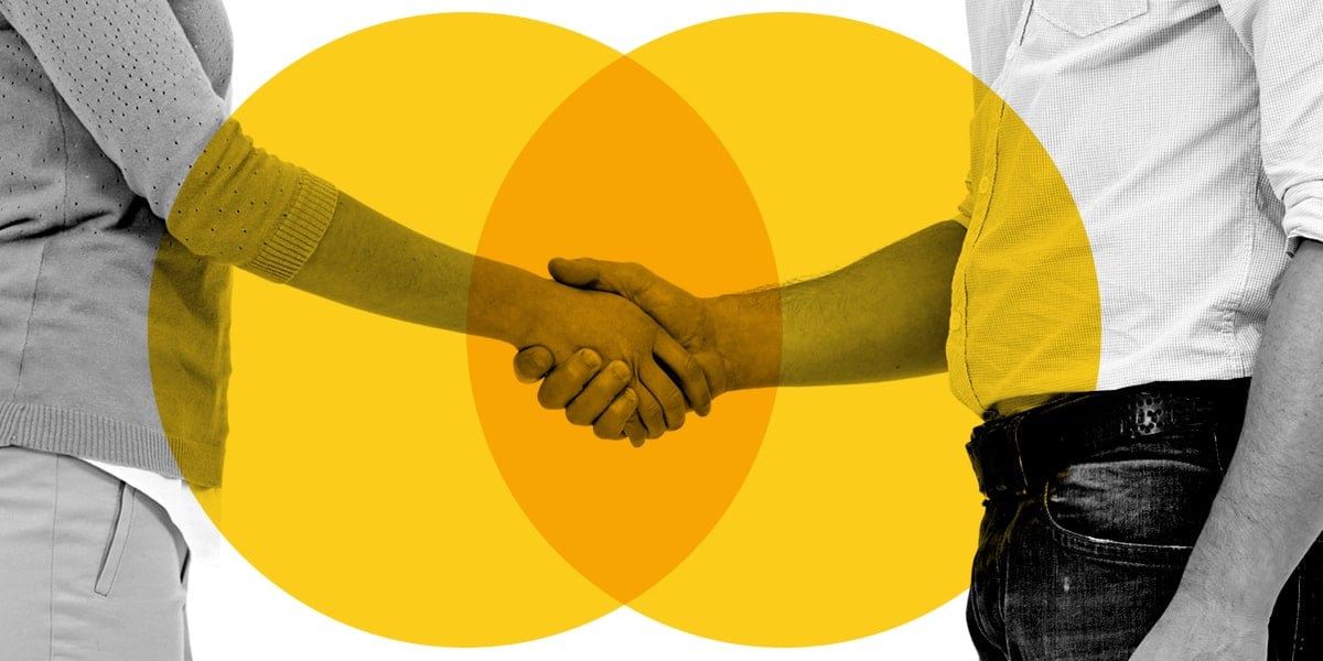 A man and woman shake hands, symbolizing a partnership between a client and the Zoe agency